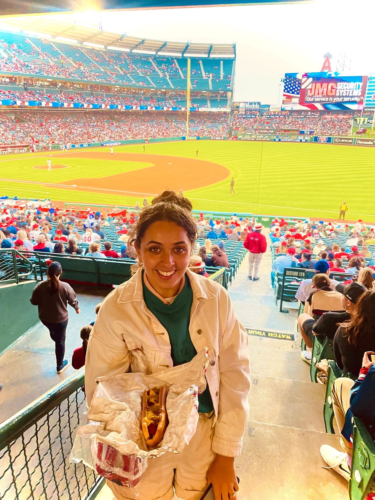 A happy me with a gluten free hot dog at a ball game
